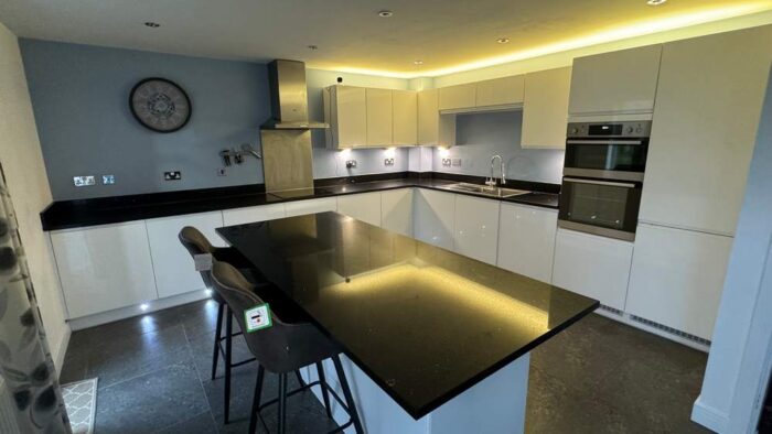 Modern White Gloss J Handled Kitchen with Island and Utility Room – AEG Zanussi Appliances – Black Granite Worktops